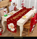Chemin de table de Noël rouge DULUXE au Père Noël et inscription dorée, dressé sur une table de fête