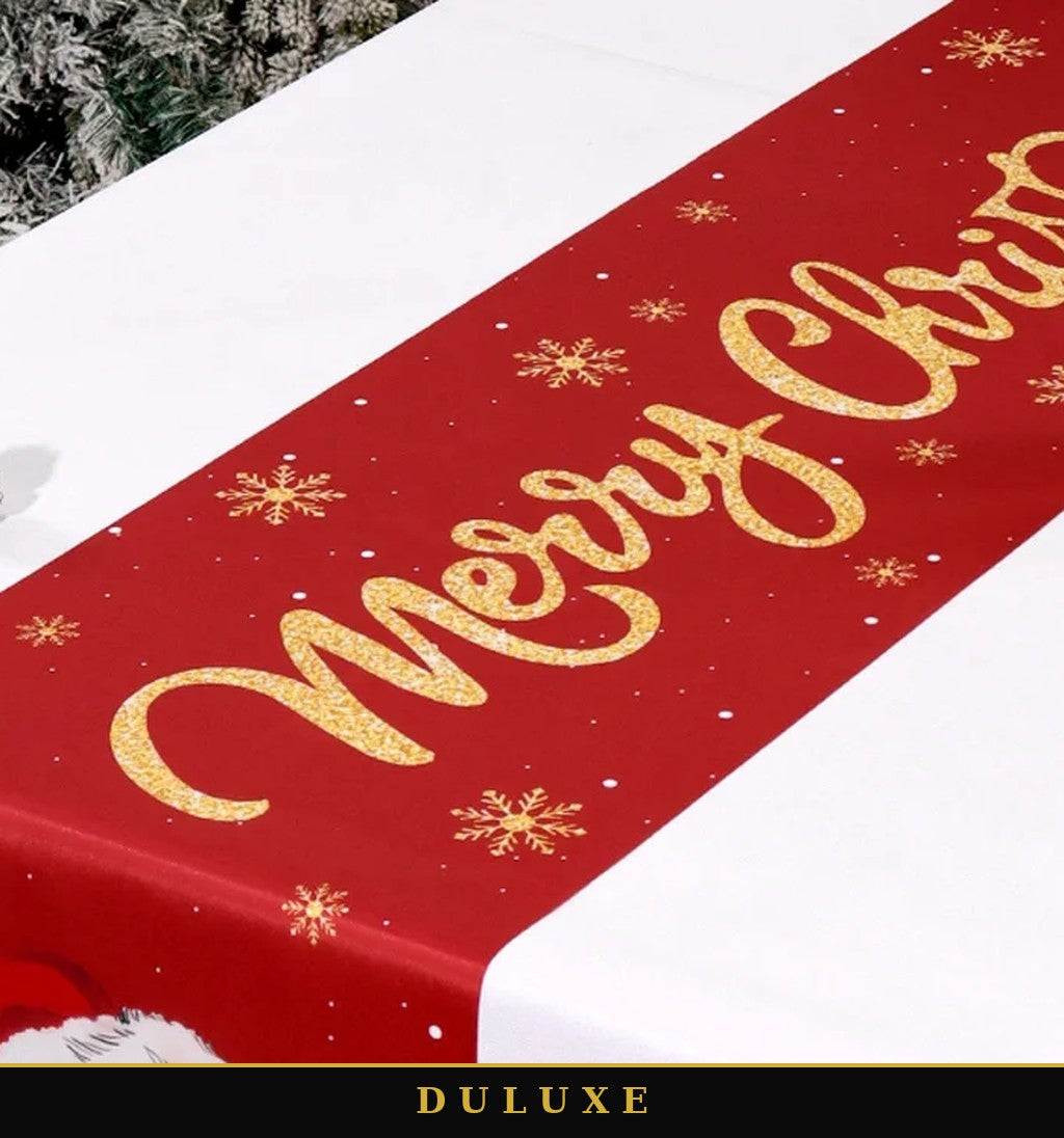 Gros plan sur l'inscription dorée festive du chemin de table de Noël DULUXE