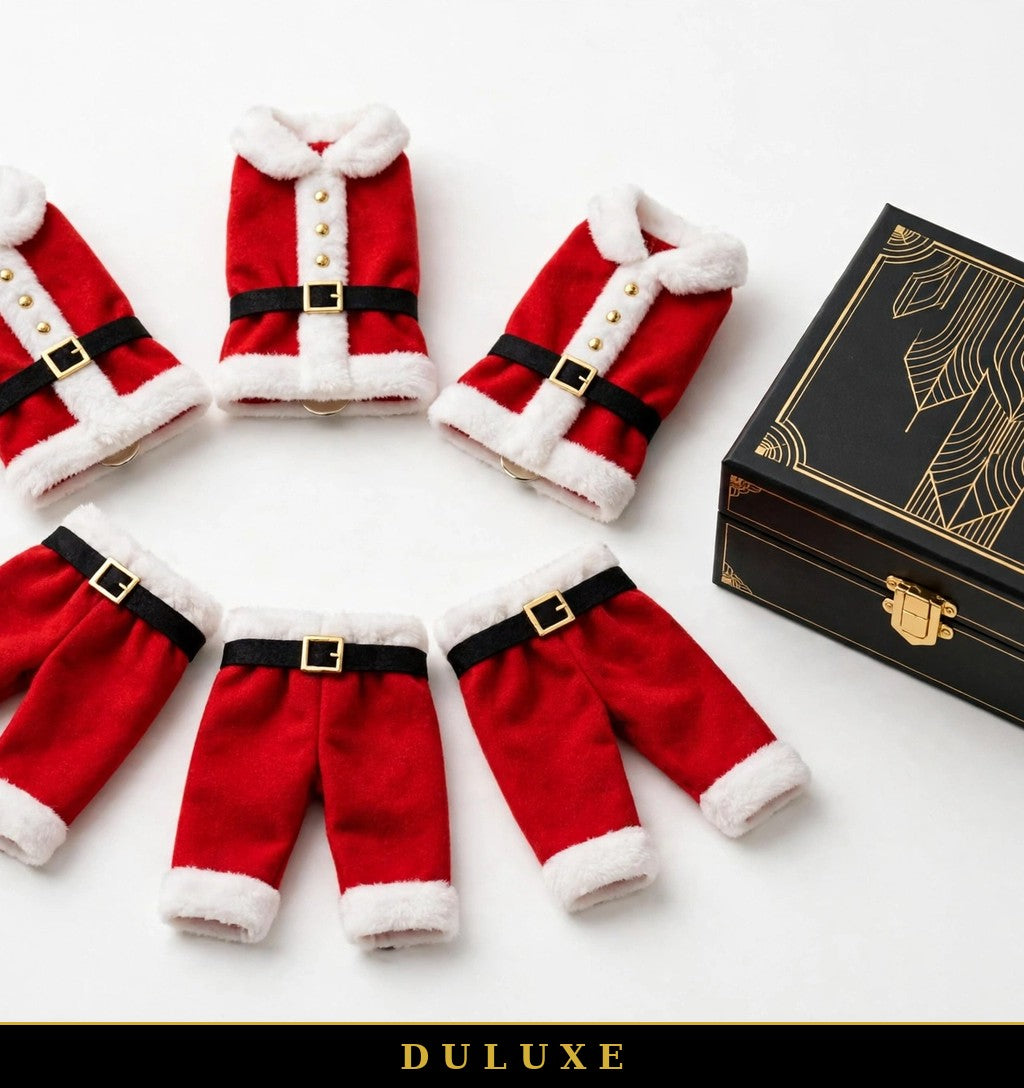 Six porte-couverts Père Noël DULUXE en éventail près d'un coffret noir et doré